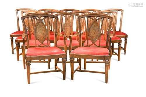 A set of fourteen walnut dining chairs including two armchai...