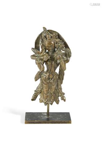 A West Tibetan fragmentary bronze figure of the four armed d...