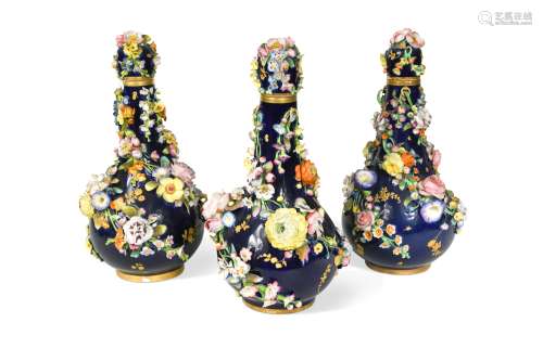 A garniture of three Derby bottle vases and covers, circa 18...