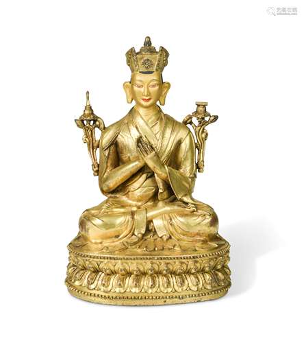 A Tibetan or Mongolian gilt bronze lama,