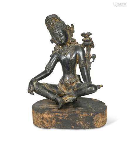 A Nepalese bronze Tara on wood stand