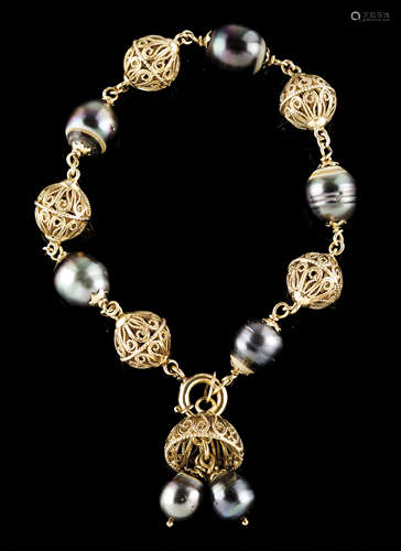 A braceletGold Pieced spheres alternating with Southern Seas...