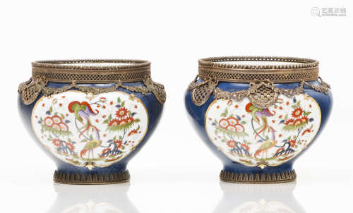 A pair of cachepotsPolychrome porcelain of floral frames dec...