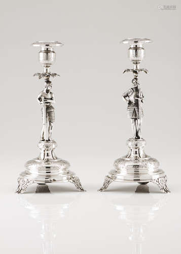 A pair of candle standsPortuguese silver Medieval warrior sh...