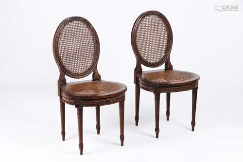 A pair of Louis XVI style chairsCarved and gilt wood Caned s...