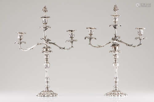 A pair of three branch candelabraSilvered metal Profuse rais...