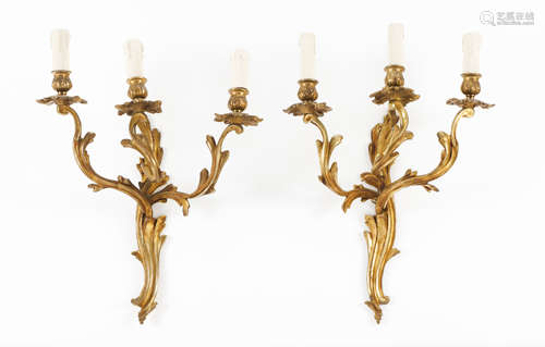 A pair of Louis XV style three branch wall sconcesGilt bronz...