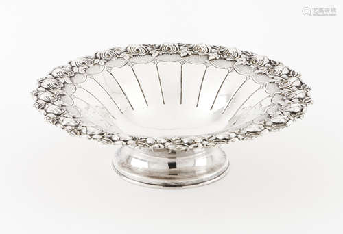 A footed fruit bowlSilver Grooved body, raised and engraved ...