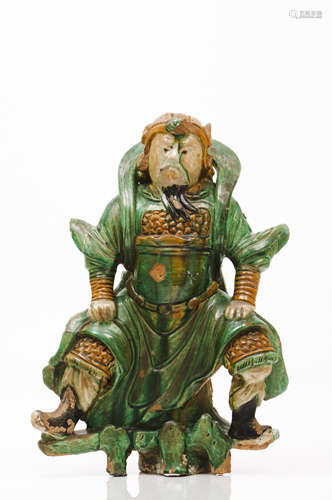 A warriorGreen and brown glazed ceramics depicting a warrior...