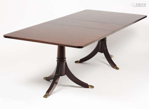 A dining tableSolid and veneered mahogany Rectangular top Su...