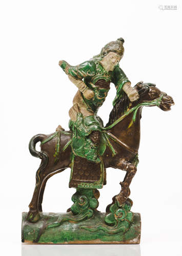 A potGreen and brown glazed ceramics depicting a horse ridin...