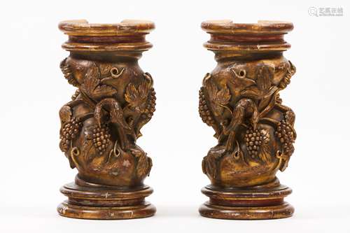 A pair of low columnsCarved and gilt wood of grapes and bird...