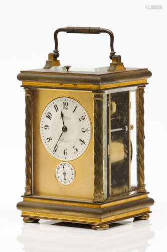 A carriage clockYellow metal Ceramic and metal dial with mak...