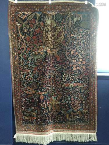 A KIRMAN PART SILK ‘TREE OF LIFE’ BORDERED RUG