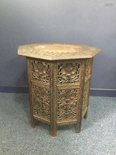 AN INDIAN CARVED WOOD FOLDING TABLE