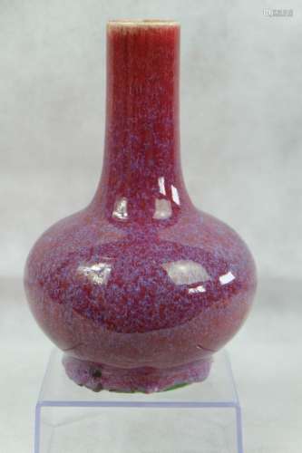 A CHINESE FLAMBÉ BOTTLE VASE , THE RED BODY WITH LAVENDER ST...