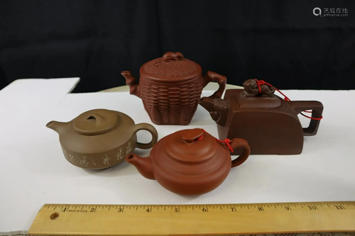 Four Chinese Yixing teapots.