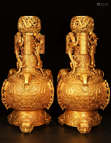 A pair of gilt dragon vases from the Qing Dynasty,