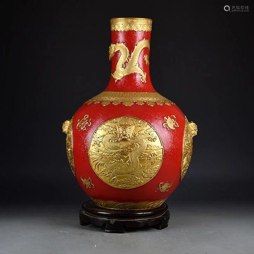 A gilt embossed celestial vase with red background and