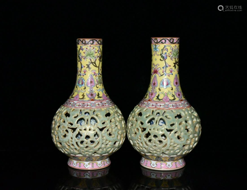 A pair of enamel and gold carved hollow vases in