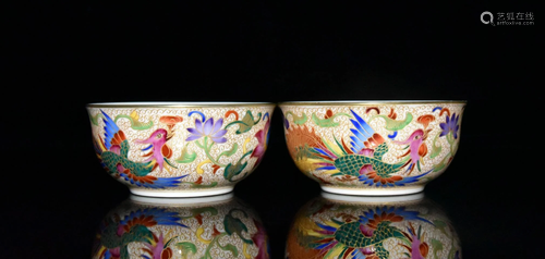 A pair of cups with gold and phoenix patterns carved by