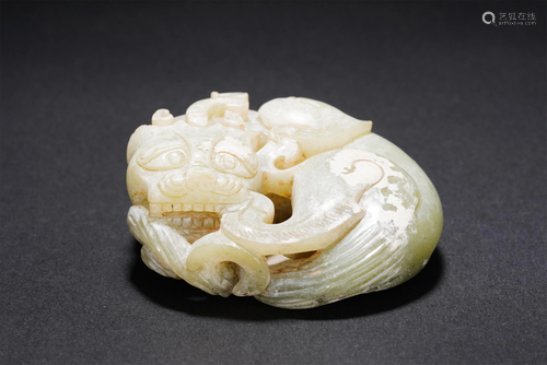 A CHINESE WHITE JADE CARVED MYTHICAL BEAST PAPERWE…