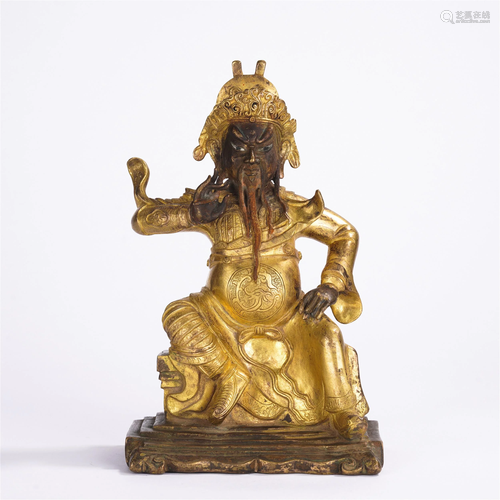 A CHINESE GILT BRONZE SEATED FIGURE OF GUAN-GONG