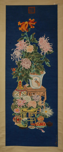 A CHINESE SCROLL PAINTING OF FLOWERS AND DECORATIONS