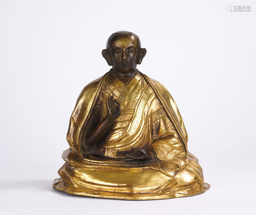 A CHINESE GILT BRONZE SEATED FIGURE OF GURU