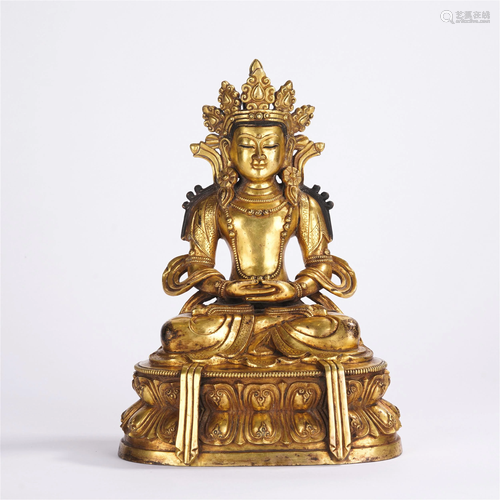 A CHINESE GILT BRONZE SEATED FIGURE OF BUDDHA