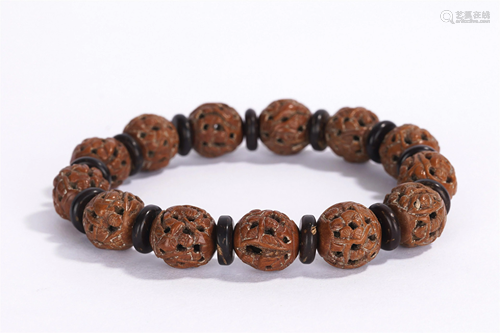 A CHINESE WALNUT CARVED BRACELET