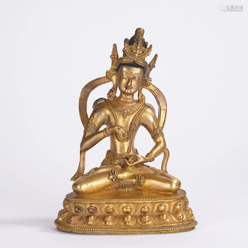 A CHINESE GILT BRONZE SEATED FIGURE OF BUDDHA