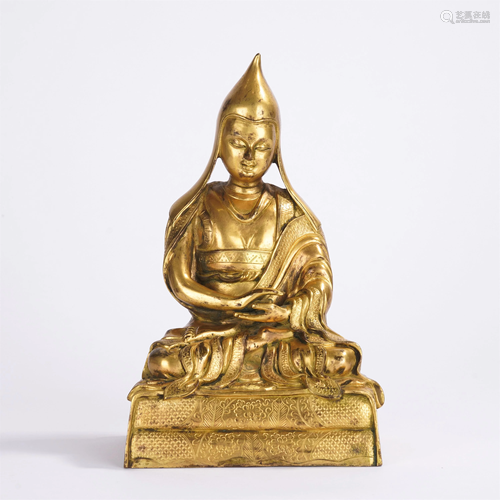 A CHINESE GILT BRONZE SEATED FIGURE OF GURU