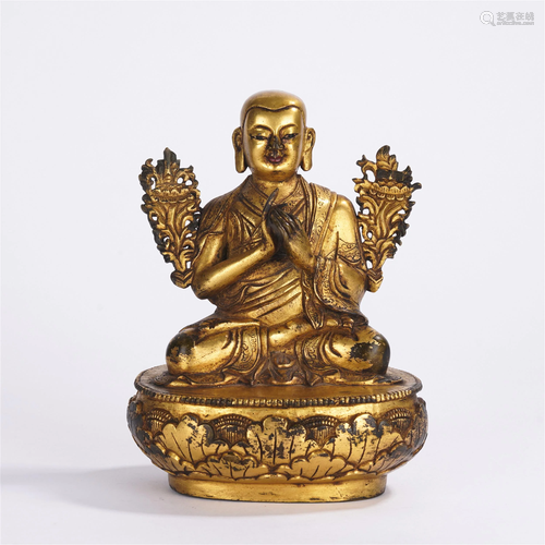 A CHINESE GILT BRONZE SEATED FIGURE OF GURU