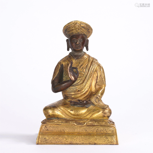 A CHINESE GILT BRONZE SEATED FIGURE OF GURU