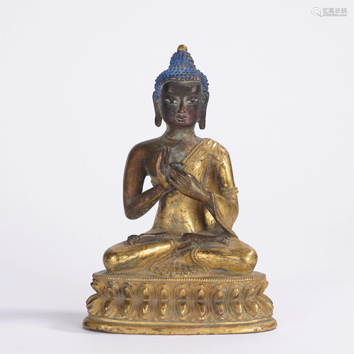 A CHINESE GILT BRONZE SEATED FIGURE OF SAKYAMUNI