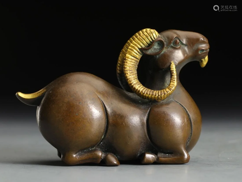 A GILT BRONZE CROUCHING RAM ORNAMENT