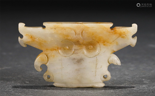 A CHINESE JADE CARVED FACE-SHAPE DECORATION