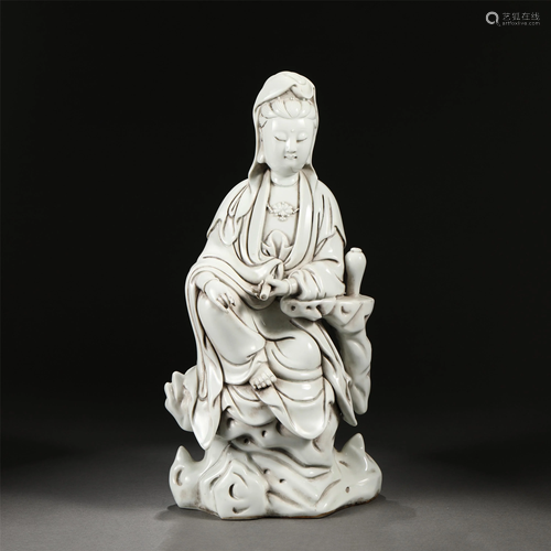 A CHINESE WHITE GLAZED PORCELAIN SEATED FIGURE OF