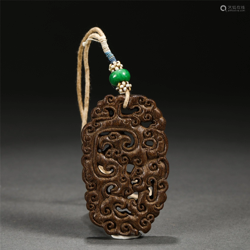 A CHINESE HOLLOW-OUT CHENXINAG WOOD PENDANT