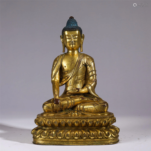 A CHINESE GILT BRONZE SEATED FIGURE OF SAKYAMUNI