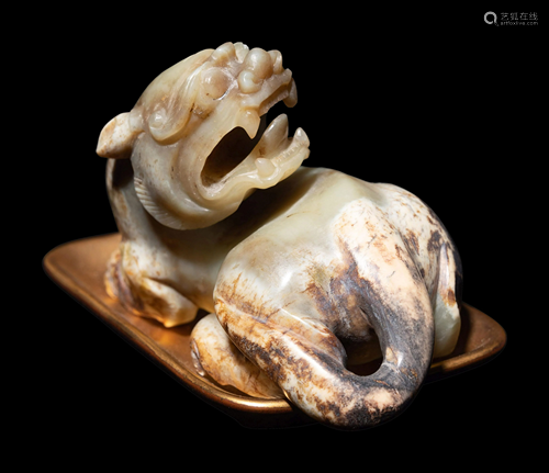 A Chinese Celadon Jade Figure of a Recumbent Bixie