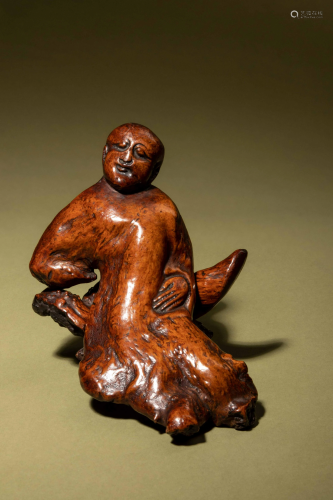 A Chinese Carved Root Figure of a Reclining Man and