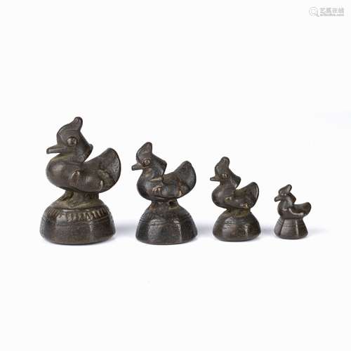 Four graduated bronze opium weights Nepalese each in the for...