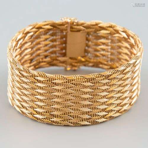 Bracelet articulé en or jaune 18K 750°. Poids 50,3g.