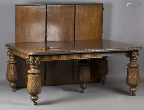 A large late Victorian carved oak extending dining table, th...