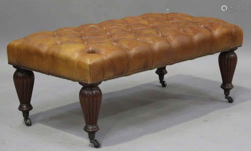 A modern buttoned brown leather footstool, height 43cm, widt...