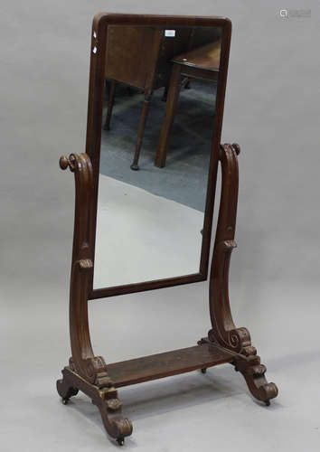 A Victorian mahogany cheval mirror, the scroll supports on c...