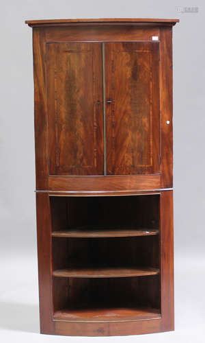 A George III and later figured mahogany corner cabinet-on-st...