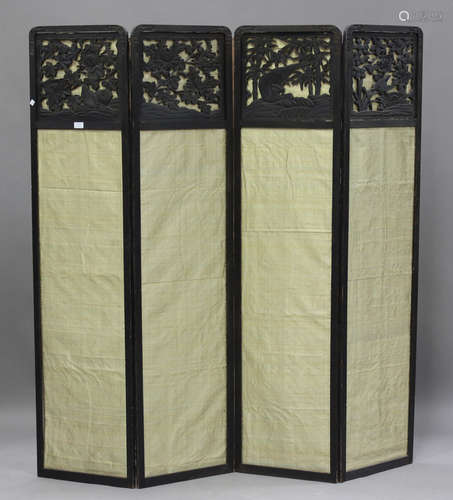 A Japanese carved and stained softwood four-fold dressing sc...